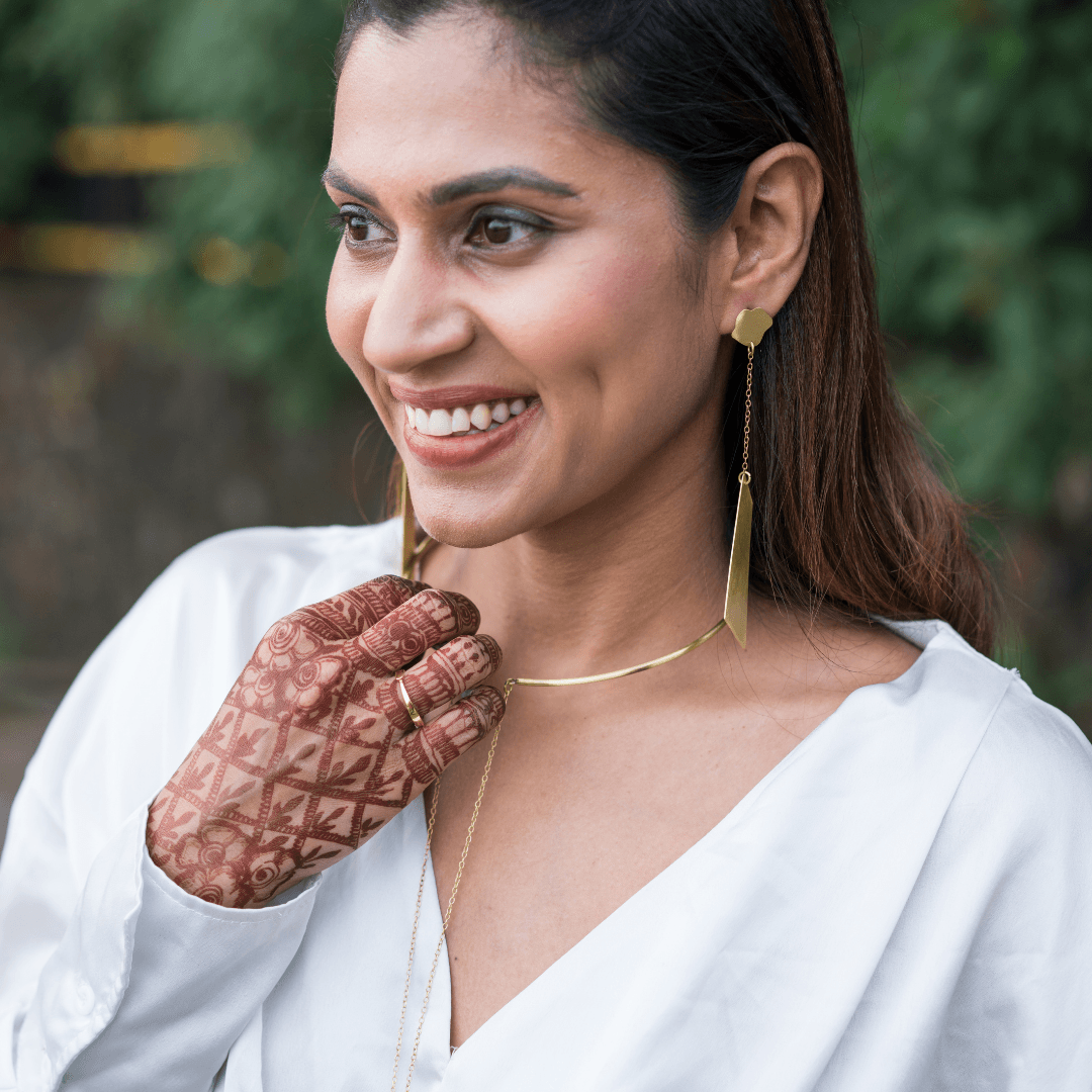 Model wearing Gold plated brass long dangling earrings